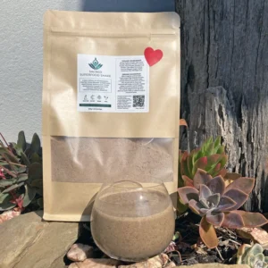 Eco-friendly kraft paper pouches of Organic Vegan Superfood Smoothie Blend, 500g, with a red heart label, photographed outdoors in natural light.
